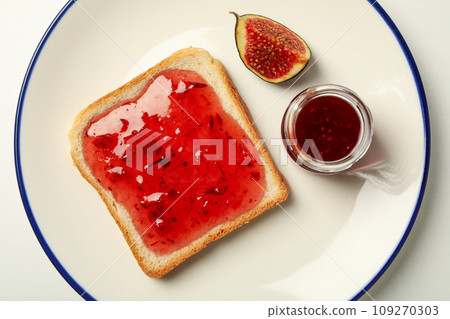 Figs, jam and piece of bread on plate on white background, top view Figs, jam and piece of bread on plate on white background, top view 109270303