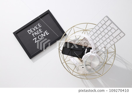 Headphones, smartphone and keyboard in the trash 109270410