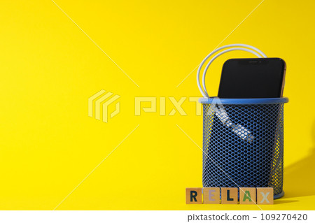 The concept of digital detoxification, a smartphone in a trash can The concept of digital detoxification, a smartphone in a trash can 109270420