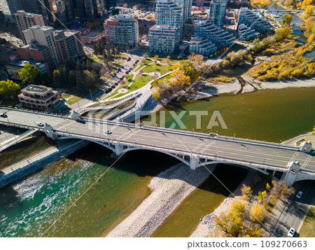 Prince's Island Park autumn foliage scenery. Aerial view of Downtown City of Calgary Centre St Bridge. Alberta, Canada.  109270663