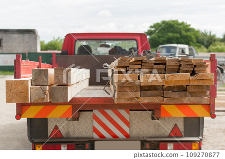 Wooden planks bars immersed in car trailer. Wood Industry, Transportation 109270877
