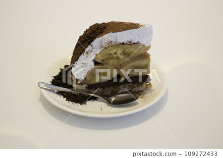 Banoffee cake with bananas and whipped cream in cafe restaurant Banoffee cake with bananas and whipped cream in cafe restaurant 109272433