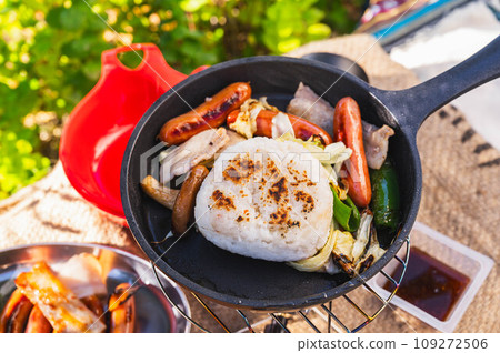 Rice balls and sausages baked in a skillet 109272506