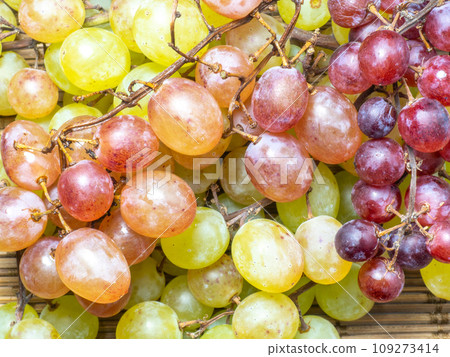 Green variety of grapes on the table. Berry harvest. Home furnishings. Kishmish on the table. Grapes of different colors. Fruit dessert. Wine ingredient. 109273414