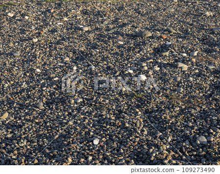 Rock on the sand. Rubble on the ground. Stones scattered on the ground. Rock on the sand. Rubble on the ground. Stones scattered on the ground. 109273490