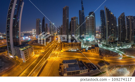 Aerial panorama of Dubai Downtown skyline with many towers night to day timelapse. 109274117