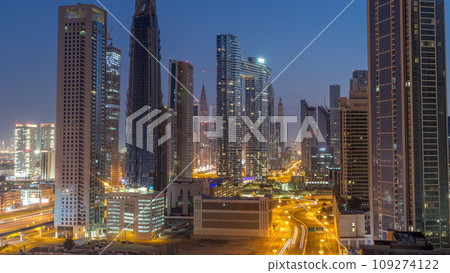 Many towers and skyscrapers with traffic on streets in Dubai Downtown and financial district night to day timelapse. Many towers and skyscrapers with traffic on streets in Dubai Downtown and financial district night to day timelapse. 109274122