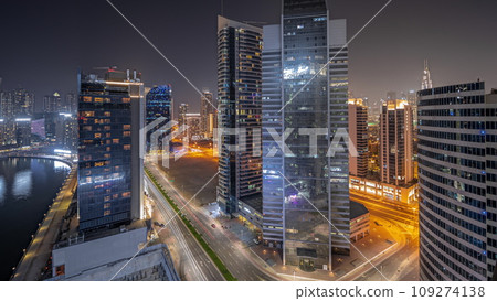 Panorama showing cityscape of skyscrapers in Dubai Business Bay with water canal aerial night timelapse Panorama showing cityscape of skyscrapers in Dubai Business Bay with water canal aerial night timelapse 109274138