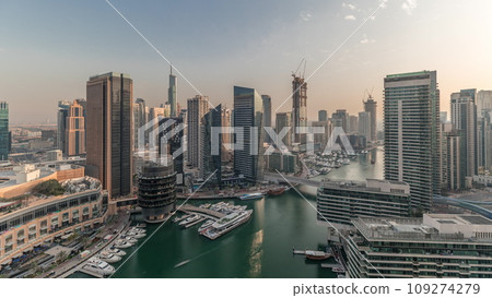 Panorama showing overview to JBR and Dubai Marina skyline with modern high rise skyscrapers waterfront living apartments aerial timelapse 109274279