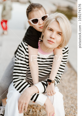 Mother hugging with her daughter outdoor in nature. Mother hugging with her daughter outdoor in nature. 109274376