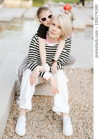 Mother hugging with her daughter outdoor in nature. Mother hugging with her daughter outdoor in nature. 109274380