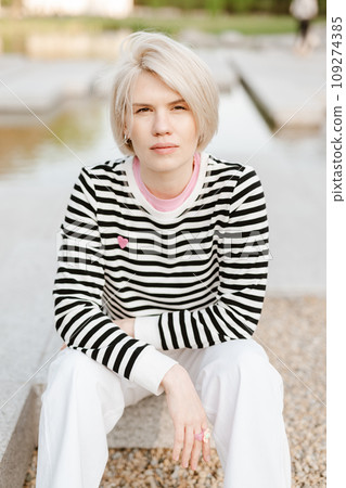 Photo of young attractive girl happy positive smile rest relax summer season park outdoors. 109274385