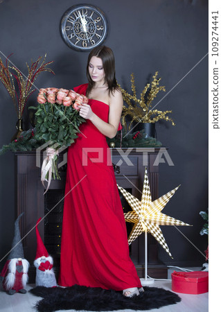Beautiful girl in a red dress with a bouquet vertical 109274441