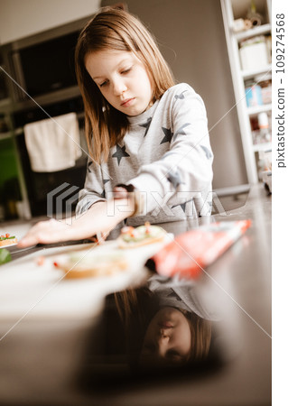 Little girl making breakfast at home 109274568