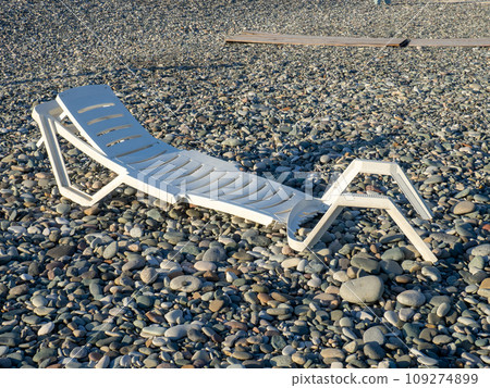 Rest on the sea. Broken beach chair. Business on the coast. Plastic trash. Rest on the sea. Broken beach chair. Business on the coast. Plastic trash. 109274899