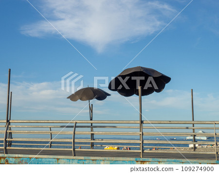 Decorative parasol on the bridge railing. Metal umbrella. Fine work. Decorative parasol on the bridge railing. Metal umbrella. Fine work. 109274900