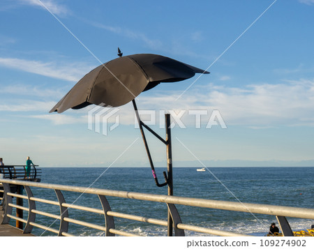 Decorative parasol on the bridge railing. Metal umbrella. Fine work. Decorative parasol on the bridge railing. Metal umbrella. Fine work. 109274902