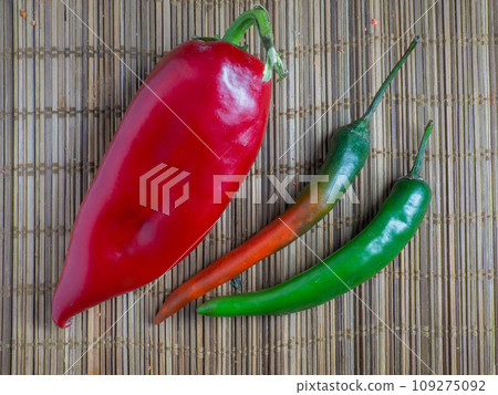 Green spicy pepper chili sweet pepper on the table. Cooking spicy dishes. Hot peppers. Acute ingredient for lunch. Green spicy pepper chili sweet pepper on the table. Cooking spicy dishes. Hot peppers. Acute ingredient for lunch. 109275092