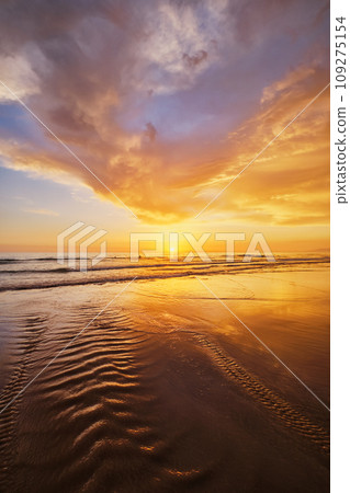 Atlantic ocean sunset with surging waves at Fonte da Telha beach, Costa da Caparica, Portugal 109275154