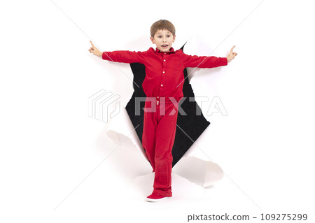 A child from a hole in paper. Boy shows cardboard. The concept of surprise and novelty 109275299