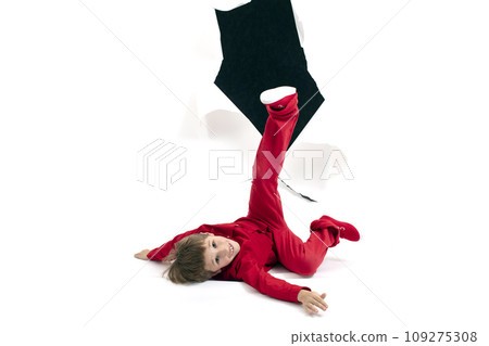 A child from a hole in paper. Boy shows cardboard. Fall out of the billboard. A child from a hole in paper. Boy shows cardboard. Fall out of the billboard. 109275308