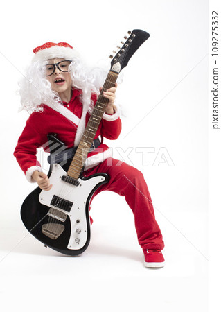 Boy dressed as Santa Claus with a guitar on a white background 109275332