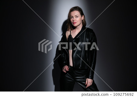 Portrait of a beautiful woman in 40 years old in black clothes in the dark Portrait of a beautiful woman in 40 years old in black clothes in the dark 109275692