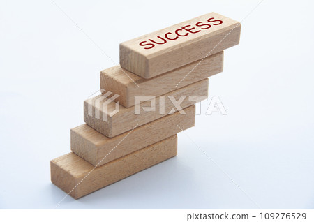 Success text on top of wooden blocks with white cover background. Success concept. Success text on top of wooden blocks with white cover background. Success concept. 109276529