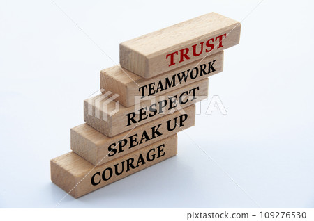 Courage, speak up, respect, teamwork and trust text on stacked wooden blocks. Courage, speak up, respect, teamwork and trust text on stacked wooden blocks. 109276530