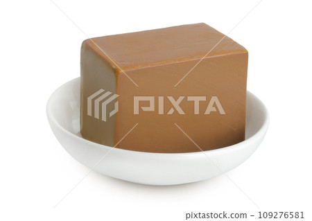 Brown cheese. Norwegian brunost in a ceramic bowl isolated on white background with full depth of field Brown cheese. Norwegian brunost in a ceramic bowl isolated on white background with full depth of field 109276581