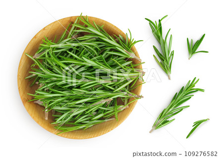 Rosemary twig and leaves in wooden bowl isolated on white background. Top view. Flat lay Rosemary twig and leaves in wooden bowl isolated on white background. Top view. Flat lay 109276582