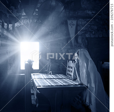 A girl sits at a table by the window in an ancient castle A girl sits at a table by the window in an ancient castle 109276715