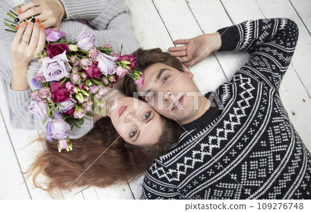 The face of a man and woman from above. Lovers with flowers. A beautiful couple. Love concept The face of a man and woman from above. Lovers with flowers. A beautiful couple. Love concept 109276748