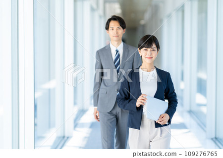 A business person walking down the aisle. 109276765