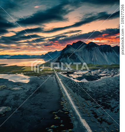 Vestrahorn mountain and road among black sand beach in the sunset at Stokksnes, Iceland Vestrahorn mountain and road among black sand beach in the sunset at Stokksnes, Iceland 109277266