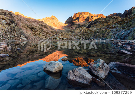 Sunrise over rocky mountain reflection in Lac Blanc at Chamonix, France Sunrise over rocky mountain reflection in Lac Blanc at Chamonix, France 109277299