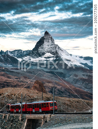 Electric train running on railway through Matterhorn mountain in Gornergrat station Electric train running on railway through Matterhorn mountain in Gornergrat station 109277305
