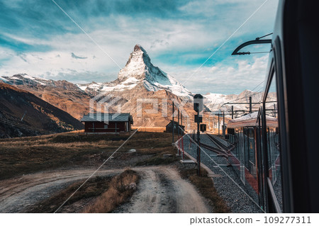 Matterhorn mountain with train running through on sunny day at Riffelboden, Zermatt, Switzerland 109277311