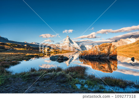 Lake Stellisee with Matterhorn mountain and stones reflection in the morning at Zermatt, Switzerland Lake Stellisee with Matterhorn mountain and stones reflection in the morning at Zermatt, Switzerland 109277318