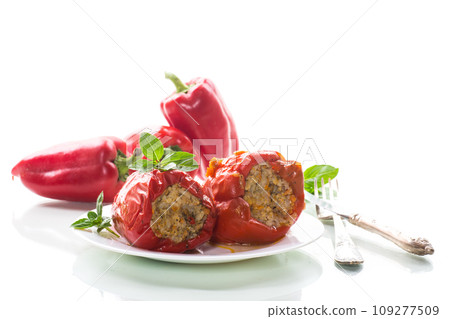 stewed in gravy stuffed peppers in a plate . 109277509