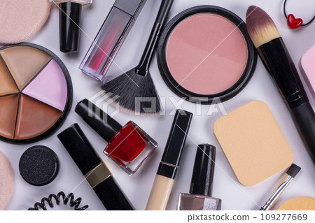background with decorative cosmetics, blush, concealer, powder, shadows, nail polish, make-up brushes, brushes for eyelashes or eyebrows on a white background, the concept of cosmetic care products background with decorative cosmetics, blush, concealer, powder, shadows, nail polish, make-up brushes, brushes for eyelashes or eyebrows on a white background, the concept of cosmetic care products 109277669