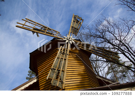 Wooden mill on a background of blue sky. Wooden mill on a background of blue sky. 109277888