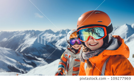 Portrait of a happy, smiling children snowboarder against the backdrop of snow-capped mountains at a ski resort, during the winter holidays. Portrait of a happy, smiling children snowboarder against the backdrop of snow-capped mountains at a ski resort, during the winter holidays. 109277969