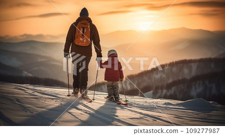 Dad and daughter high in the snowy mountains at a ski resort, doing extreme sports, watching the sunset during vacation and winter break. 109277987