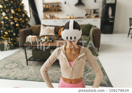 A young, beautiful woman shares her thoughts and feelings while wearing a virtual reality headset. A young, beautiful woman shares her thoughts and feelings while wearing a virtual reality headset. 109278634