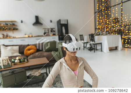 The young and beautiful woman recounts her feelings while donning a virtual reality headset. 109278642