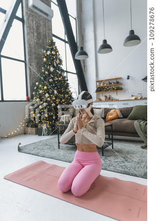 Amidst the New Year's celebrations, a yoga coach conducts online classes with the aid of a virtual reality headset. Amidst the New Year's celebrations, a yoga coach conducts online classes with the aid of a virtual reality headset. 109278676