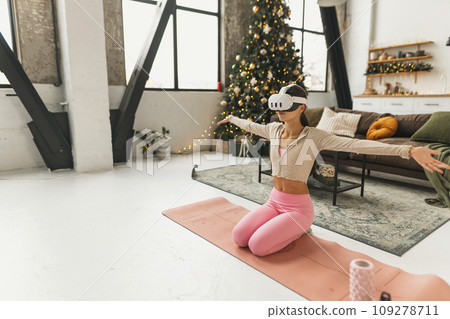 A young, beautiful woman shares her feelings while wearing a virtual reality headset. A young, beautiful woman shares her feelings while wearing a virtual reality headset. 109278711