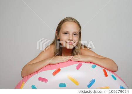 Beautiful happy child girl with inflatable ring swimming float closeup. Beautiful happy child girl with inflatable ring swimming float closeup. 109279034