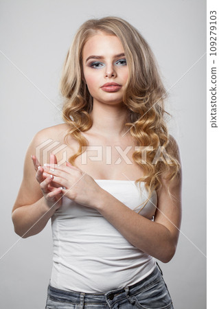 Cute lady with curly hairdo standing on white background. Beauty woman portrait 109279103